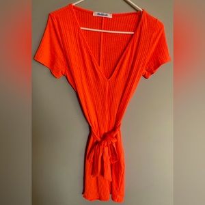 Baddieville one-piece romper in the color orange. Size Large. Lightly worn.